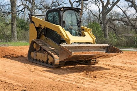 using a skid steer to grade|leveling ground with skid steer.